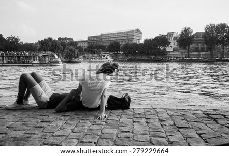 PARIS - SEP 06: people rest near Seine river on September 06, 2014 in Paris, France. Paris, aka City of Love, is a popular travel destination and a major city in Europe