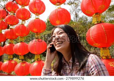 Chinese woman talking on cell phone during chinese new year