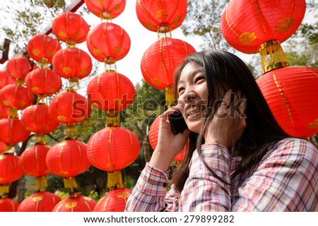Chinese woman talking on cell phone during chinese new year