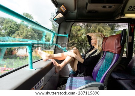 Woman on second floor of double-decker bus in Hong Kong