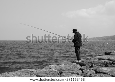 GENEVA - SEP 11: man fishing at Geneva lake on September 11, 2014 in Geneva, Switzerland. Geneva is the second most populous city in Switzerland and is the most populous city of Romandy