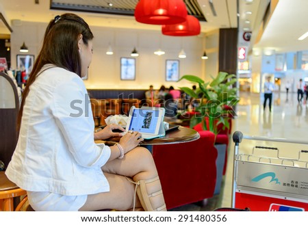 HONG KONG - JUNE 04, 2015: woman surf internet in Pacific Coffee cafe. Pacific Coffee Company is a Pacific Northwest U.S.- style coffee shop group originating from Hong Kong