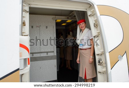 DUBAI, UAE - JUNE 23, 2015: Emirates crew member meet passengers. Emirates is one of two flag carriers of the United Arab Emirates along with Etihad Airways and is based in Dubai.