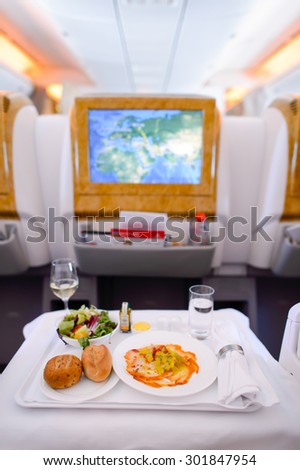 DUBAI - JUNE 23, 2015: Emirates Boeing 777 busines class interior. Emirates handles major part of passenger traffic and aircraft movements at the airport.