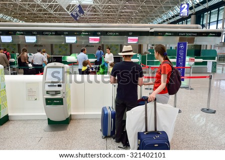 ROME, ITALY - AUGUST 16, 2015: people use self check-in kiosks in Fiumicino Airport. Fiumicino - Leonardo da Vinci International Airport is a major international airport in Rome, Italy