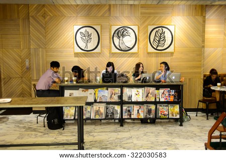HONG KONG - MAY 05, 2015: Starbucks cafe customers. Starbucks is the largest coffeehouse company in the world, with more then 23000 stores