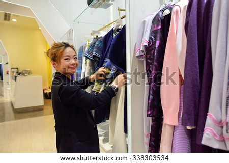 HONG KONG - NOVEMBER 02, 2015: seller work in boutique in New Town Plaza. New Town Plaza is a shopping mall in the town centre of Sha Tin in Hong Kong. Developed by Sun Hung Kai Properties