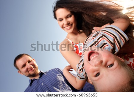 mother, father and canted child. focus on eyes of child