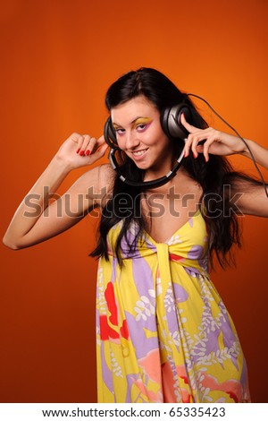 beauty woman listen music, isolated on orange