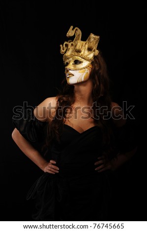 portrait of sexy woman in golden party mask isolated on black