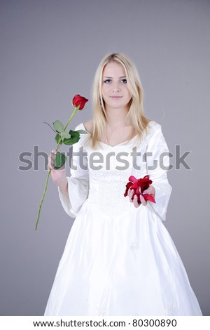 stock photo blonde woman in white wedding dress hold red rose 