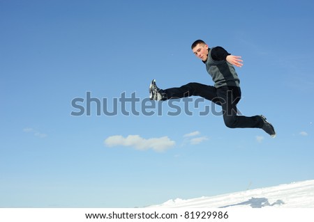 Flying man with fun grimace isolated on blue sky