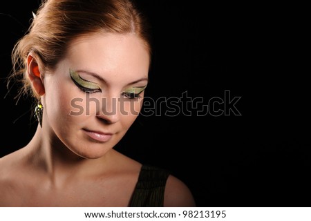 portrait of pretty calm woman with make up, isolated on black