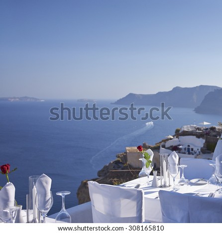 prepared table outside a restaurant on Santorini cliff