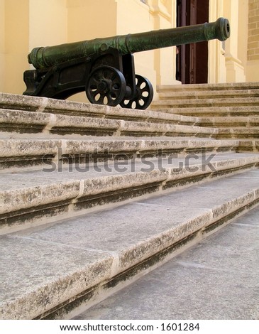 Side view of cannon sitting on stone steps