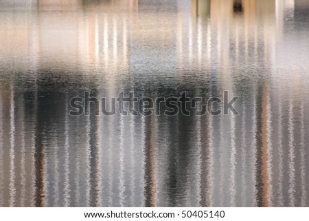 An interesting water reflection abstract of a number of small buildings
