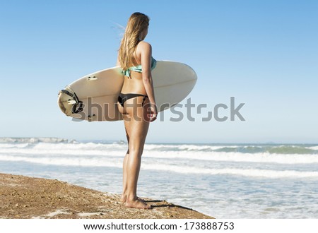 Teenage surfer girl checking the waves
