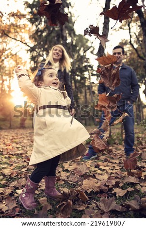 Outdoor portrait of a happy family enjoying the fall season