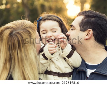 Outdoor portrait of a happy family enjoying the fall season