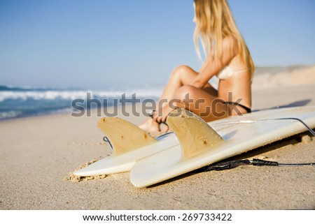 Beautiful woman on the beach getting ready for surf