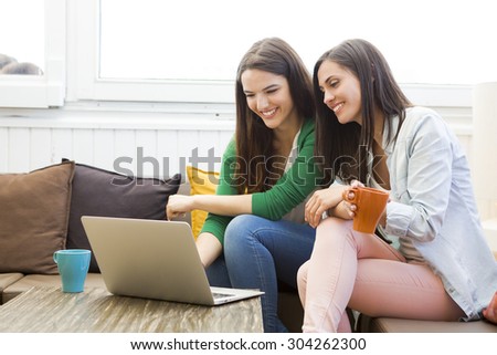 Female friends at the local coffee shop drinking coffee and working