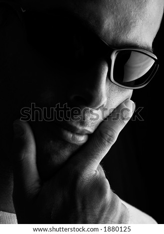 Man portrait with eyeglasses (focus in on the finger and glasses)