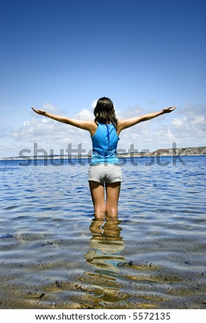 Beautiful woman in the water feeling the breeze