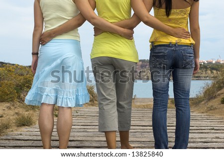 Three young girls walking to the beach