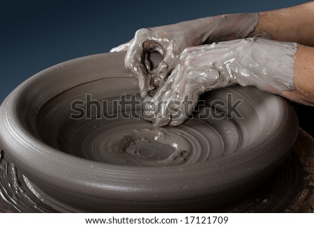 Close-up picture of a potter works a potter\'s wheel