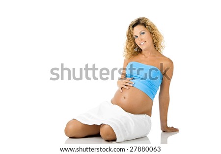 Beautiful pregnant woman seated on the floor and isolated on white background