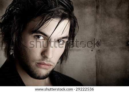 stock photo : Good looking young man with modern HairStyle over a grunge 
