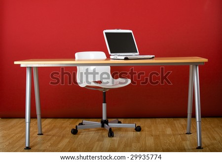 Workplace empty of people with a laptop over the desk