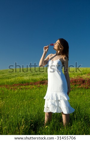 Beautiful young woman feeling the smell of the nature