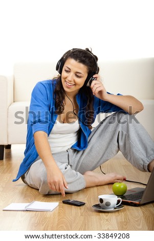 Portrait of a girl seated on floor calling on phone