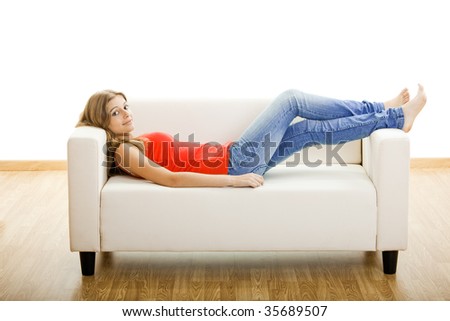 Beautiful young woman relaxing at home on the sofa