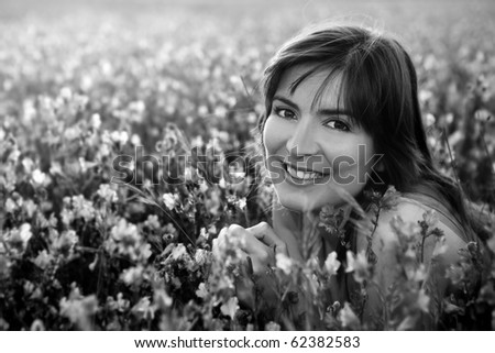 Beautiful young woman portrait on a flowery meadow