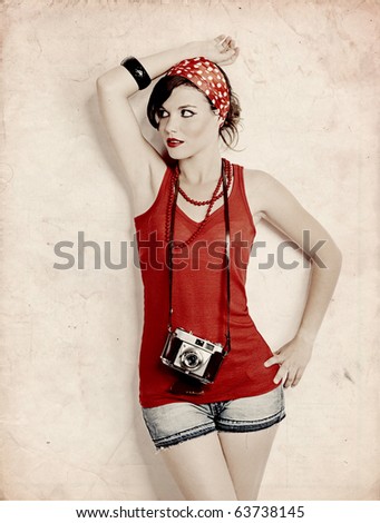 Portrait of a beautiful and fashion young woman with a photographic camera