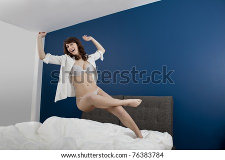 Beautiful young woman falling to the bed