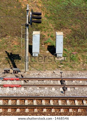Two pairs of rails and a signal post