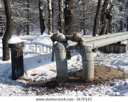 Metallic water tubes going through a nice winter forest