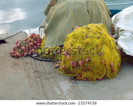 A pile of fishing nets stored on a quay
