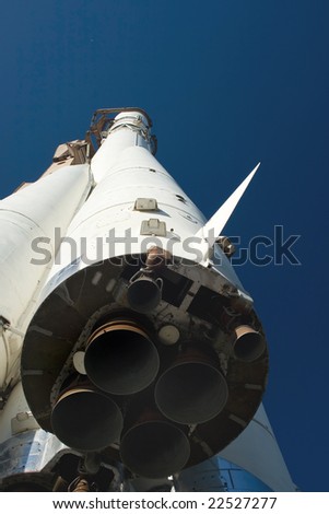 A spaceship launching rocket of the 20th century parked on a launch pad, focus on the first stage thrusters