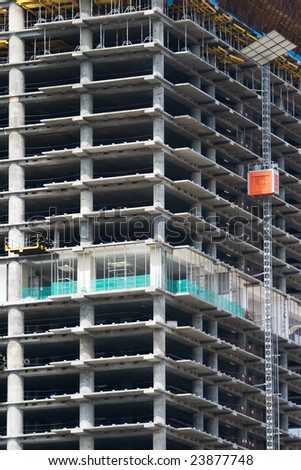 A skyscraper in construction phase with construction equipment on it
