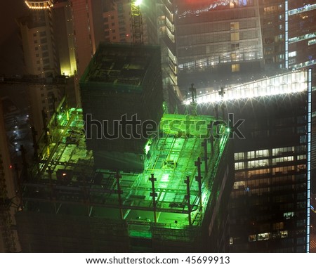 Skyscraper roofs and construction sites at night with specific lights