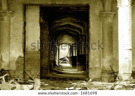 A pillared hallway with open doors in an old, forgotten castle ruin in Europe,