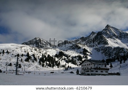 A hotel on a snowy slope in white winter landscape