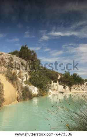 A small turquoise pool filled by a hot thermal spring in Bagno Vignoni, Tuscany