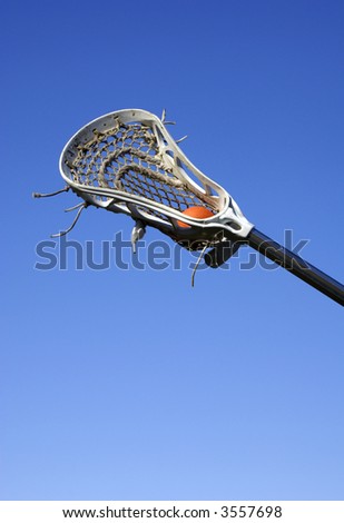 a white lacrosse stick against a blue sky