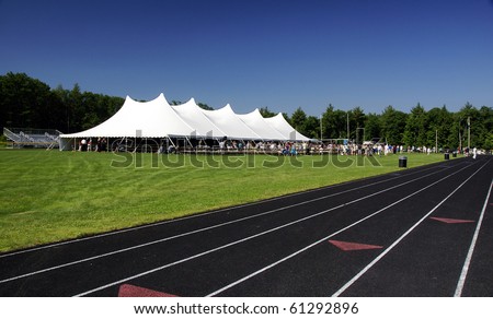 a large white tent set up in the field