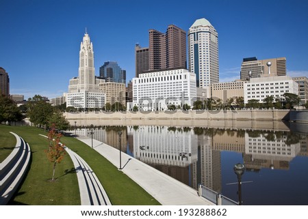 The Columbus, Ohio skyline reflected in the Scioto River.  Columbus is the capital of Ohio.